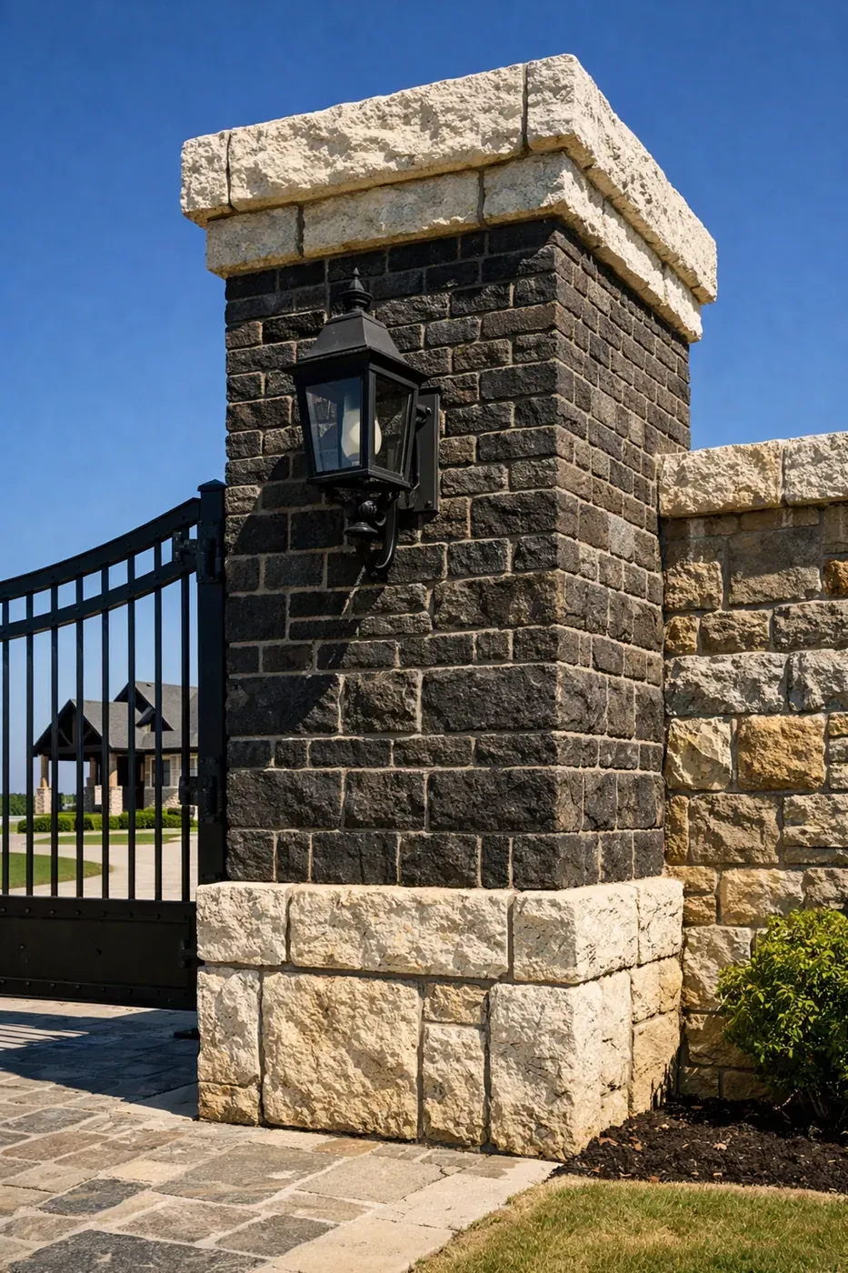 Massive brick and limestone entrance pillars on a North Texas luxury ranch showing structural integrity.