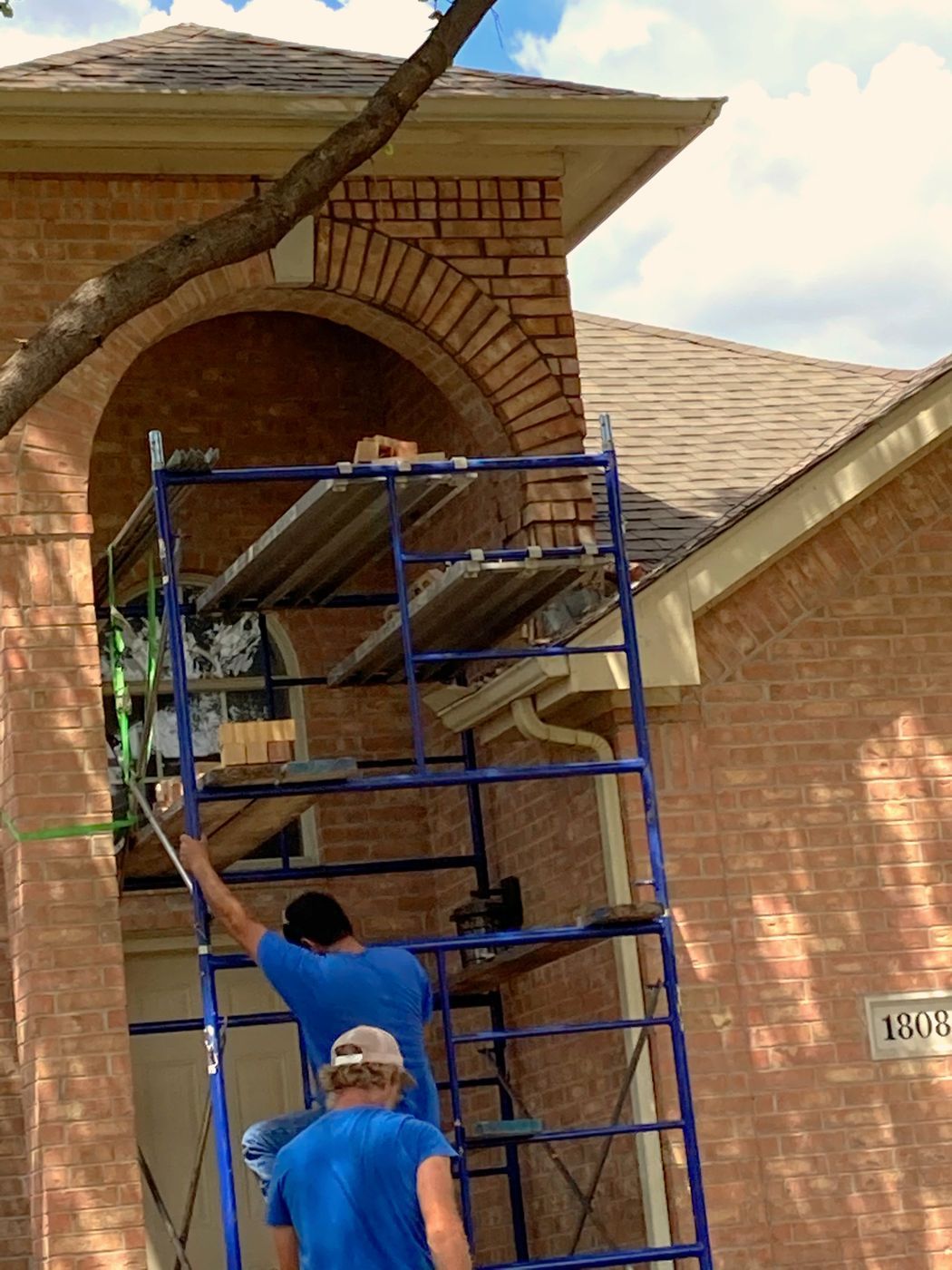 Custom stonework and masonry entryway with premium limestone and brick in a Dallas luxury estate. A grand masonry entryway featuring custom stonework and precision-laid brick.